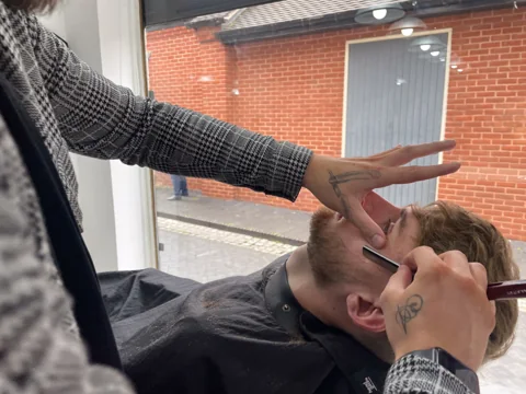 Close-up of precision beard grooming at RAGE Barbers Lounge