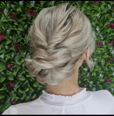 An intricately pinned blonde up-style created at RAGE