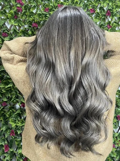 Silver blonde waves with darker dimensional roots